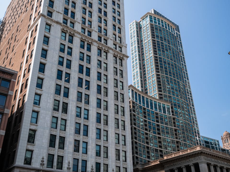 Glass office towers in a financial district seen from street level
