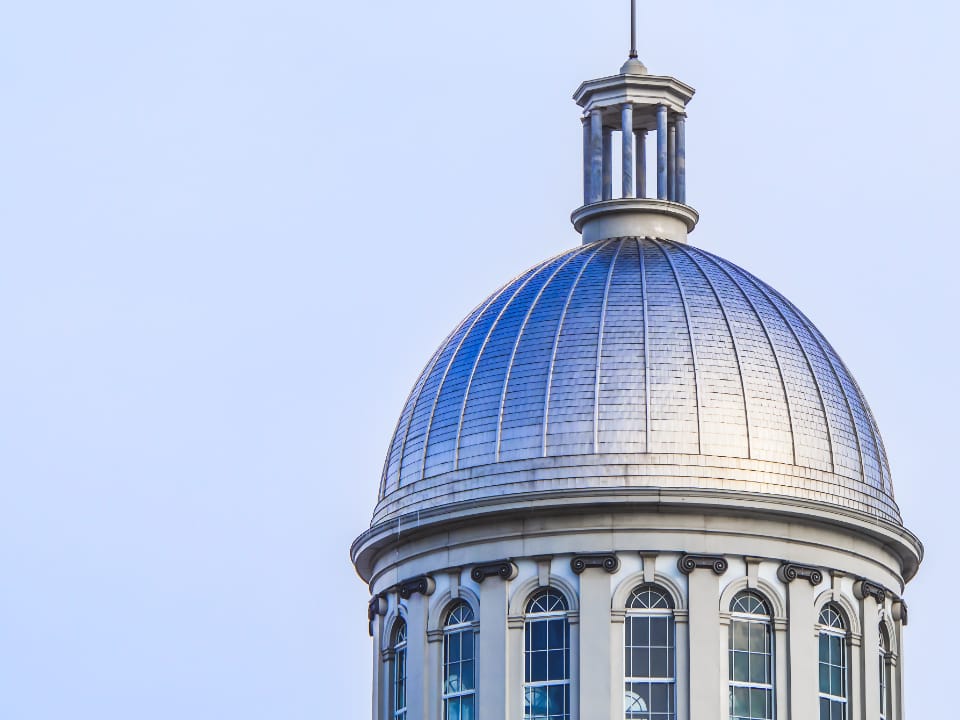 The dome of a government building against a clear sky